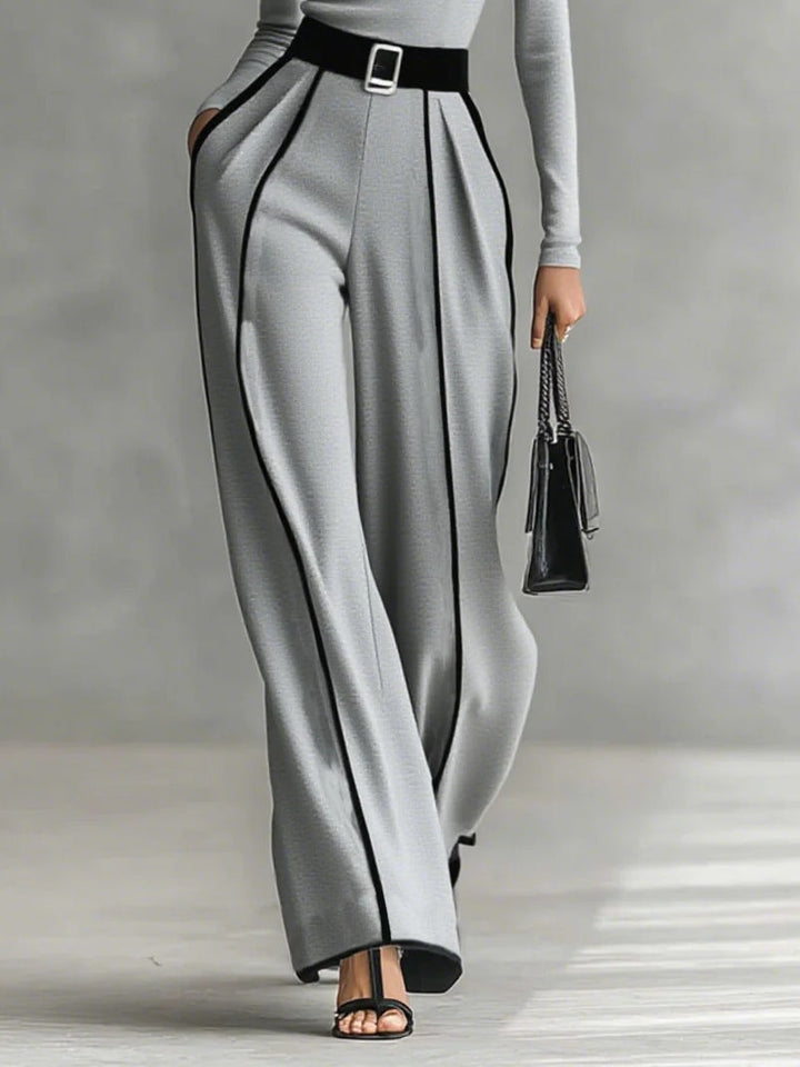 White set with high collar, long sleeves, and wide trousers with belt