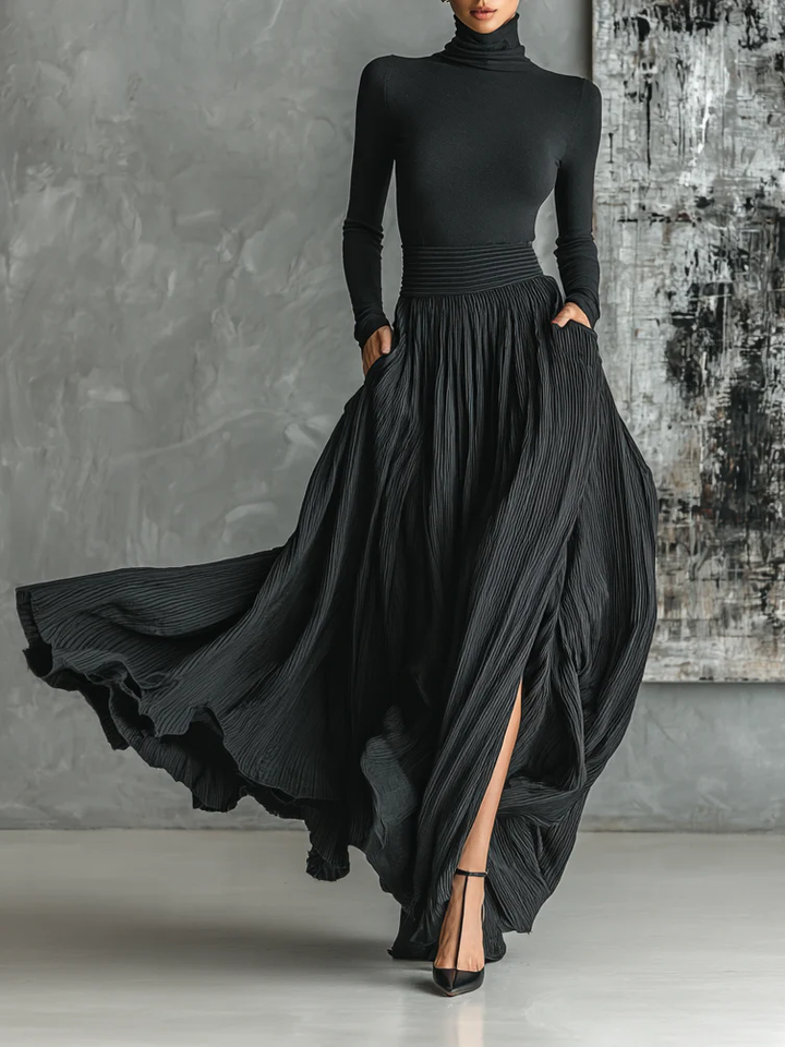 Fashionable set of a black, fitted turtleneck and a pleated skirt
