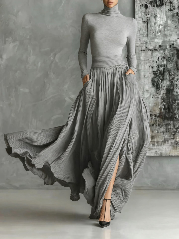 Fashionable set of a black, fitted turtleneck and a pleated skirt